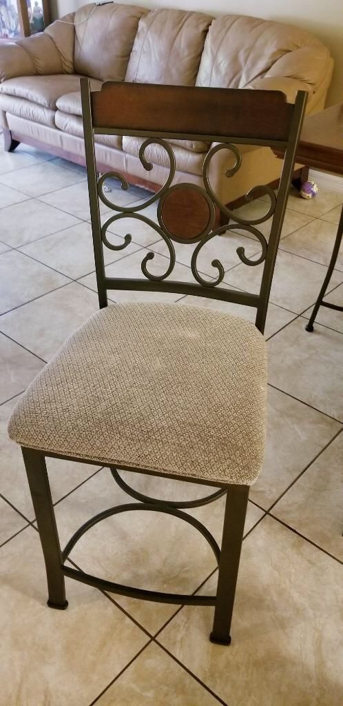 Brown dining table with built in wine rack and chairs