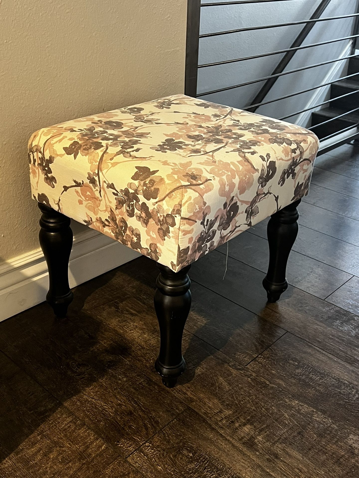 Floral ottoman with dark wood legs
