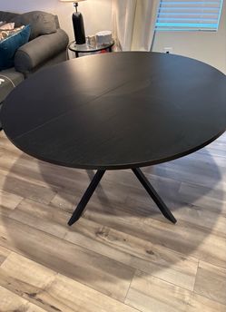 Round black table with two chairs