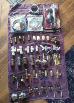 Various plumbing parts. Ball valves,  brass repair couplings, shark bite, and more.