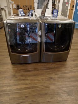 BLACK STAINLESS LG WIFI ENABLED TURBO WASHER AND DRYER SET.