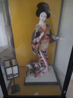 Japanese doll in glass case