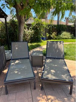 Crate and Barrel pair of outdoor loungers and table