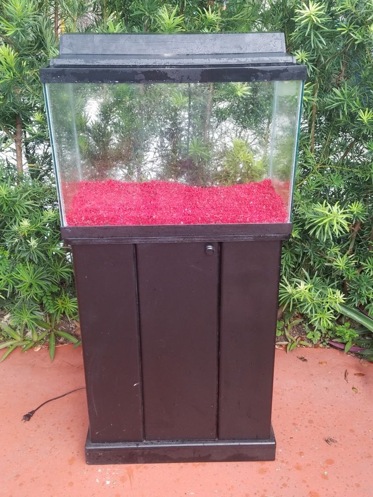 20 gallon fish tank with stand , hood, florescent light and neon red rocks