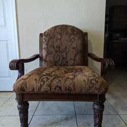 Wooden Chair With Beautiful Carving On Armrests And Legs . And Side Tables With Beautiful Carving Dying On It.