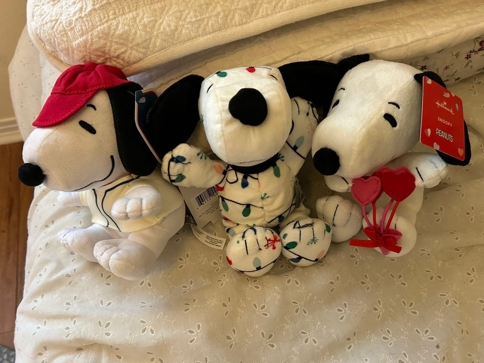 Three plush 9 inch Snoopy dolls, new, with tags, Valentines sports and Christmas