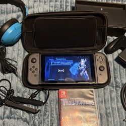 NINTENDO SWITCH WITH DOCKING STATION, TROLL HUNTERS GAME, HEADPHONES, JOYCON GRIP, HDMI AND MEMORY CARD