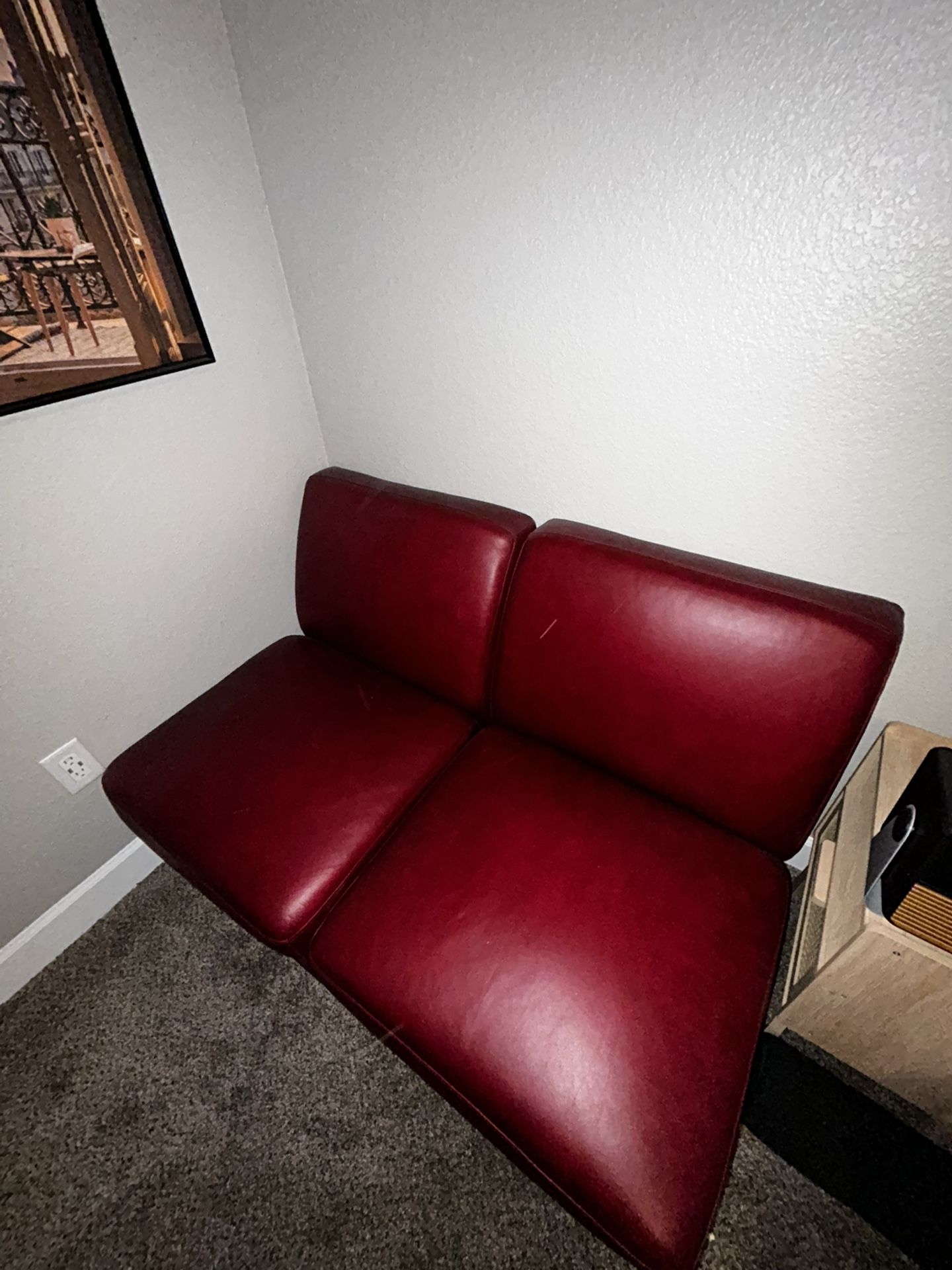 Two armless cherry red couches