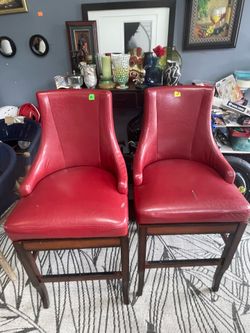 2 red leather spinning chairs