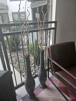 2 brown metal vases