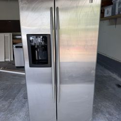 GE stainless steel side‑by‑side refrigerator with ice and water dispenser, used and fully working.