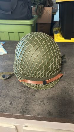 Military helmet with netting