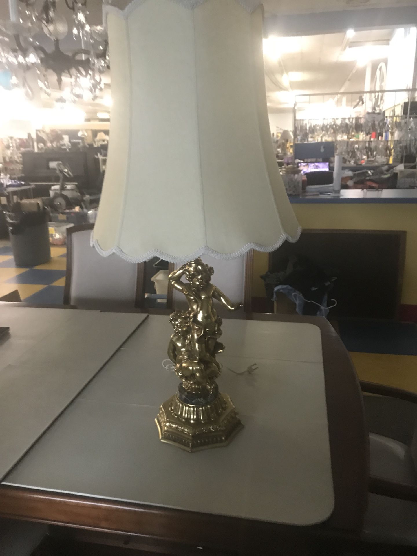 It is a Beautiful antique brass lamp with cherubs on it