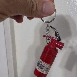 Novelty Cigarette Lighter designed to look like a miniature fire extinguisher, often sold as a keychain accessory. 