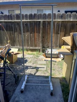 Plastic clothing rack with metal bar