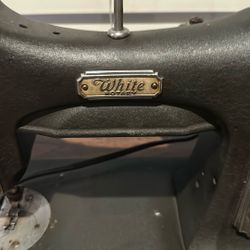 white rotary sewing machine On Cabinet 