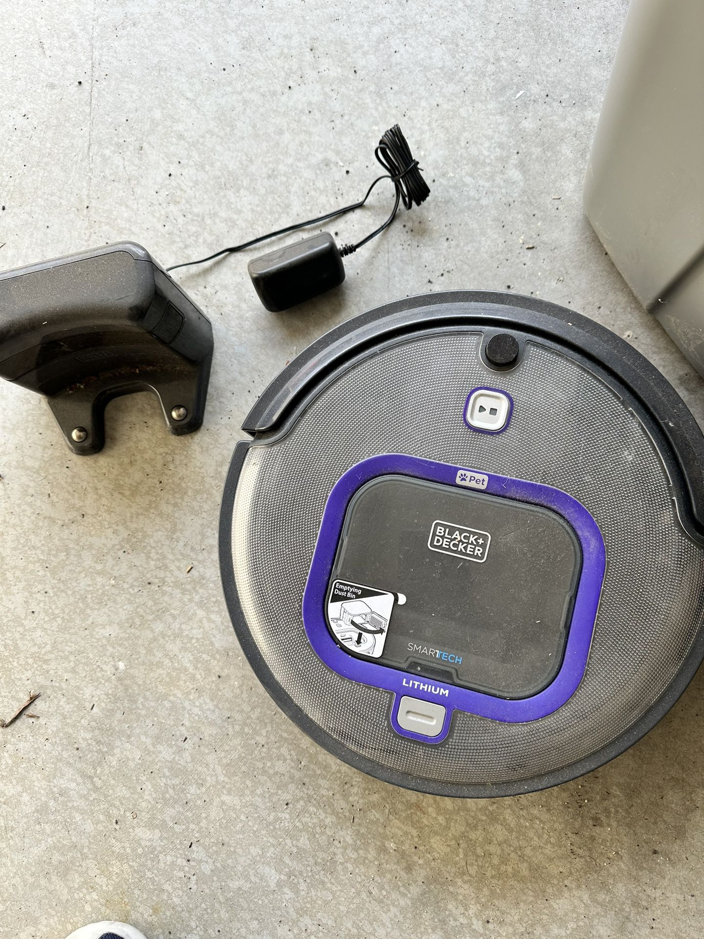 Black and decker + pet care automatic vacuum with charging dock.