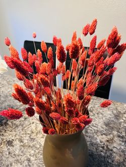 A big gold vase with real dried flowers
