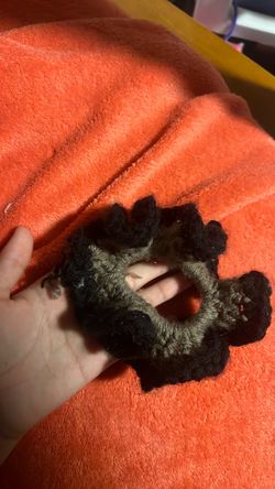 Black and gray crochet scrunchie hand