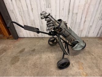 Set of golf clubs, bag, and cart