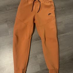 orange nike tech pants 