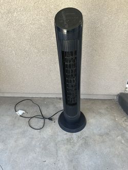 Black tower fan with power cord.