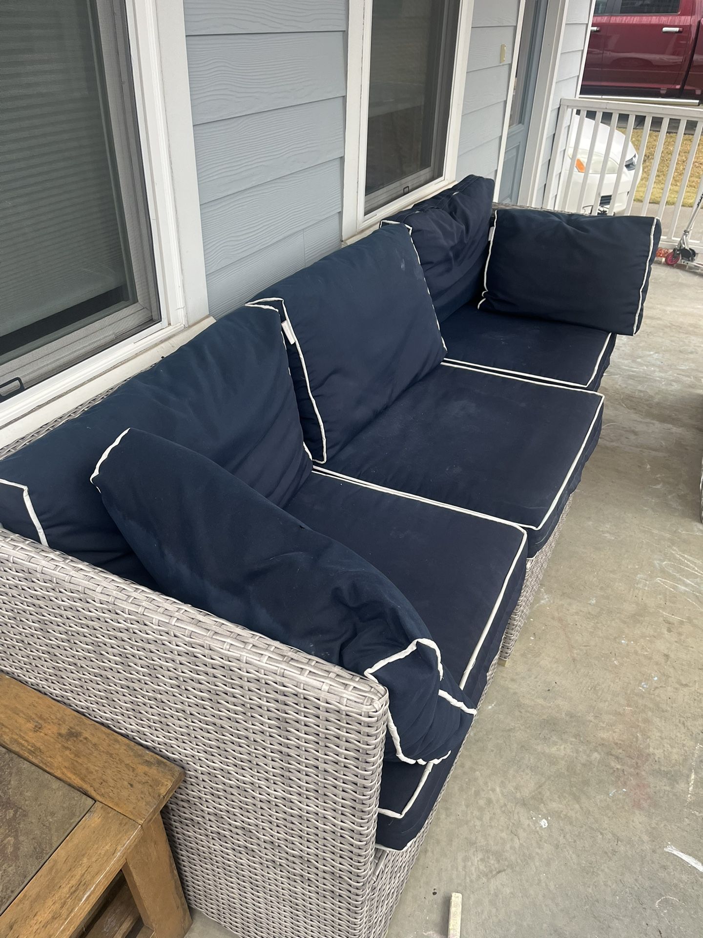 Wicker Couch With Navy Cushions   