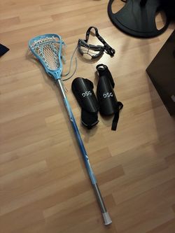 Lacrosse stick, shin guards, face mask