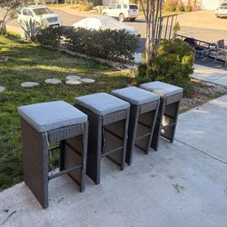 4 indoor/outdoor wicker bar stools with cushions 
