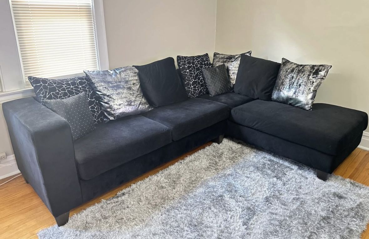 Black sectional with decorative pillows