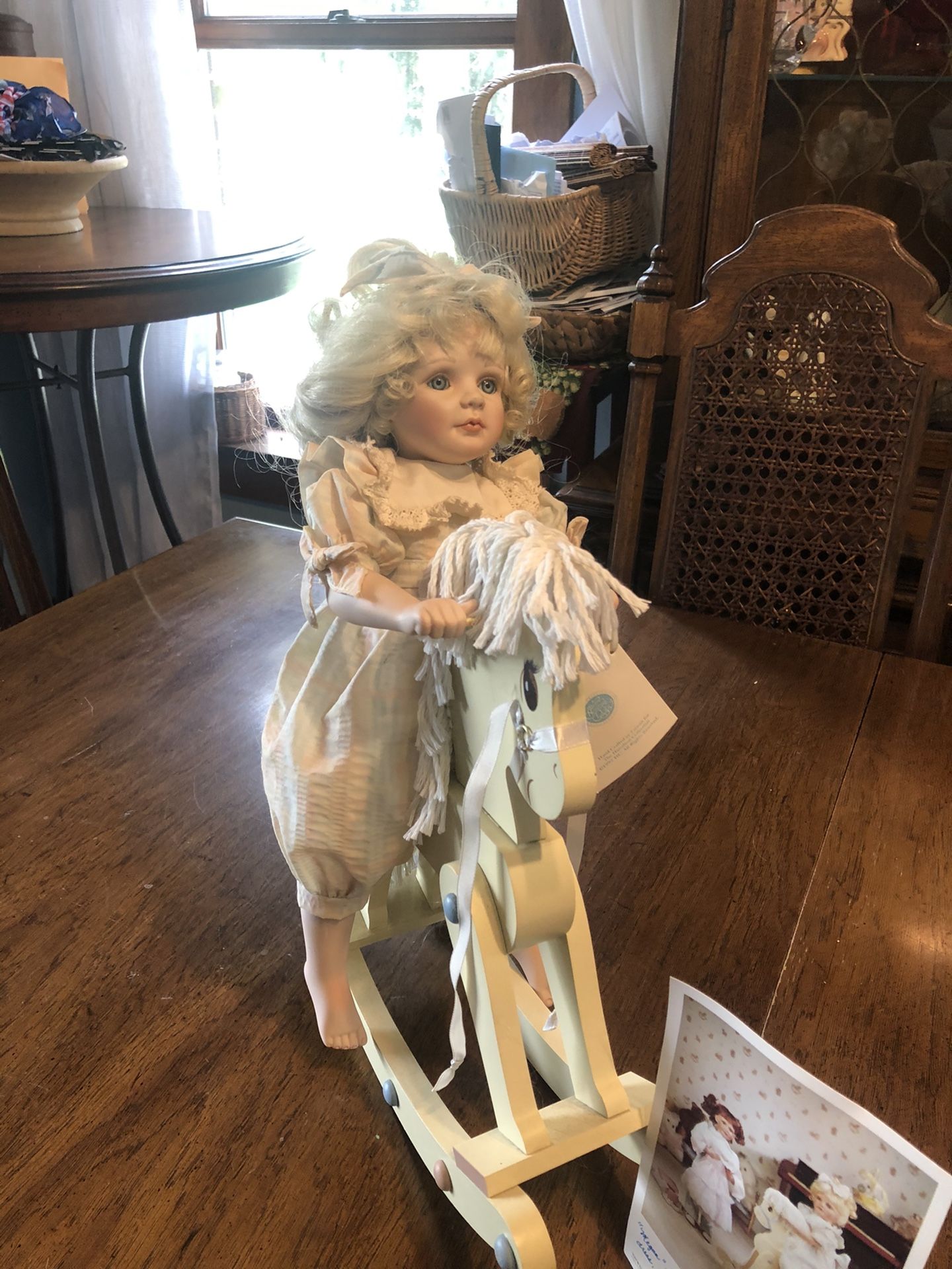 Porcelain doll on rocking horse, not a toy