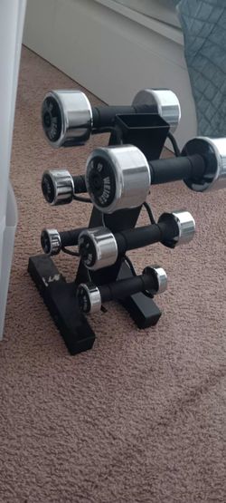 Set of Weider Chrome Dumbbells with Rubber Grips on a vertical storage rack