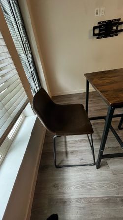 Rustic wood top pub table and Two faux-leather counter stools