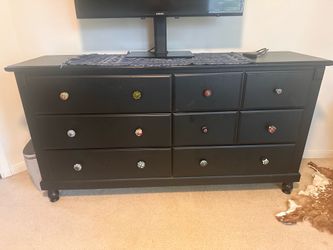 Dresser drawers, and side table with cute decorative knobs.