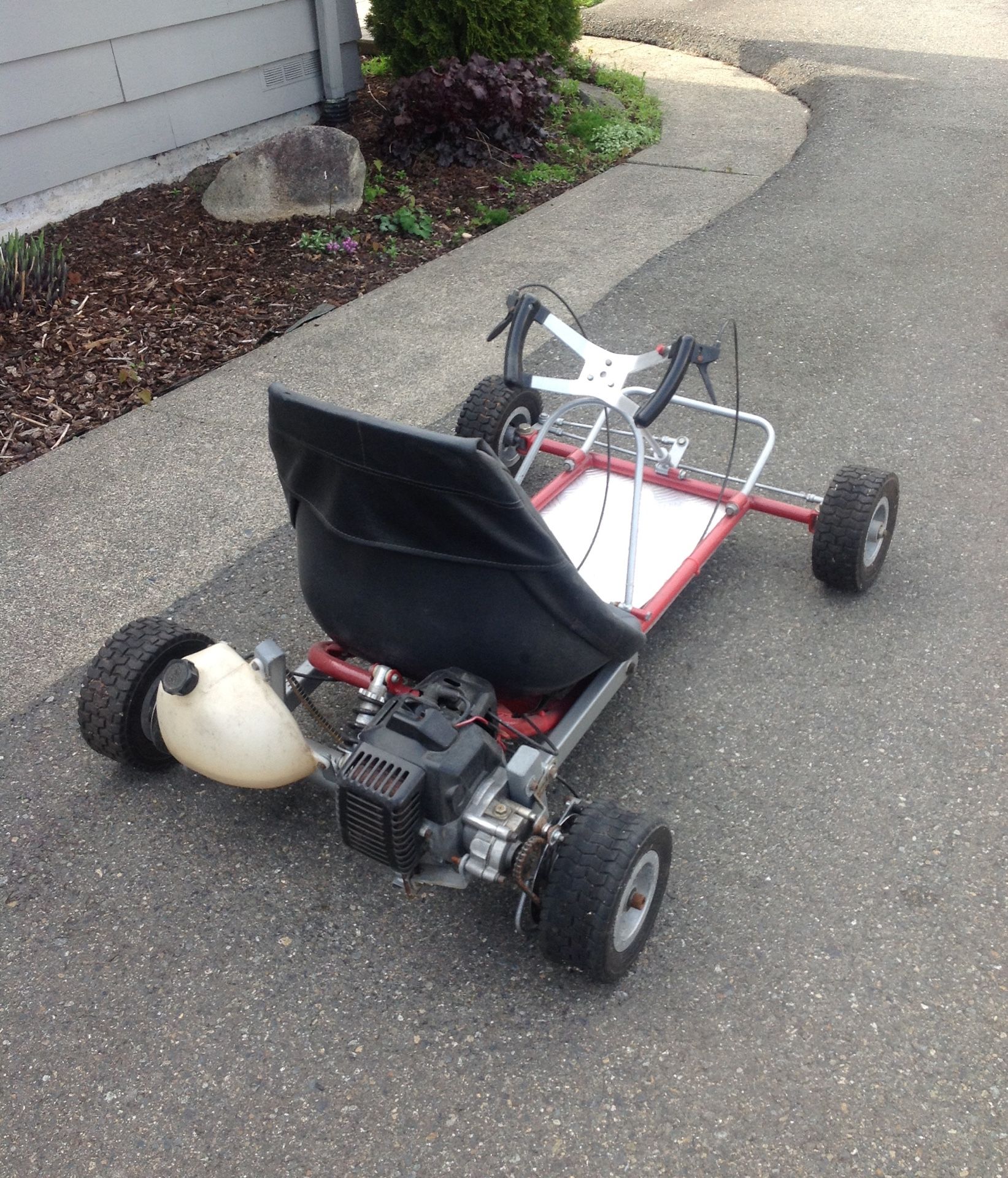 Weed wacker go kart, 23 miles an hour. Runs drives was so out to become garage art. I figured let the kids have fun