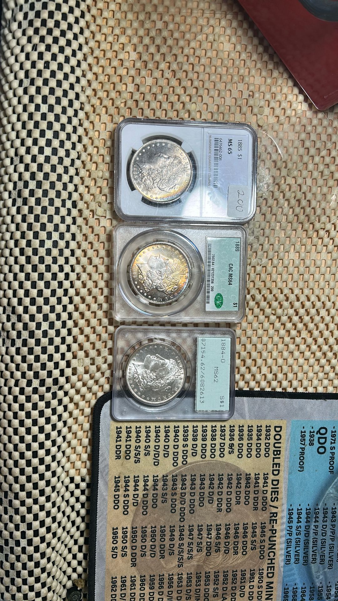 We Have Here A 1885MS 65 Morgan Silver Dollar And A 1889 Pack MS 64 Green Tag Green Beanie And A 1880 40MS 62. It’s A Rattler Old Holder. The 1885 MS 