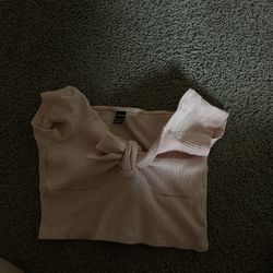 Light pink top with bow in the middle