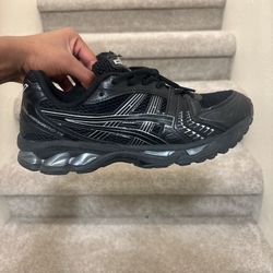 Black and white ASICS trainers