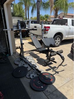 Bench press/squat rack with 7ft 45lbs bar plus 275lbs of Olympic weights plus curl bar
