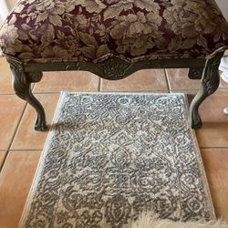 Beautiful French-style bench with carved legs and rich burgundy floral upholstery. Perfect as an entryway seat, bedroom accent, or vanity stool. The c