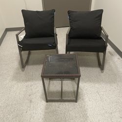 Patio Set. Both Chairs Are Rocking Chairs. One Of The Chair Has A Rust Spot .
