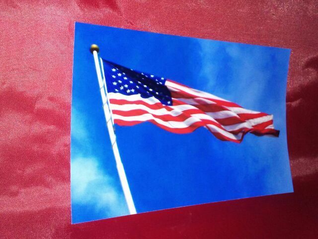 Beautiful photo of the American flag flying in the beautiful blue sky