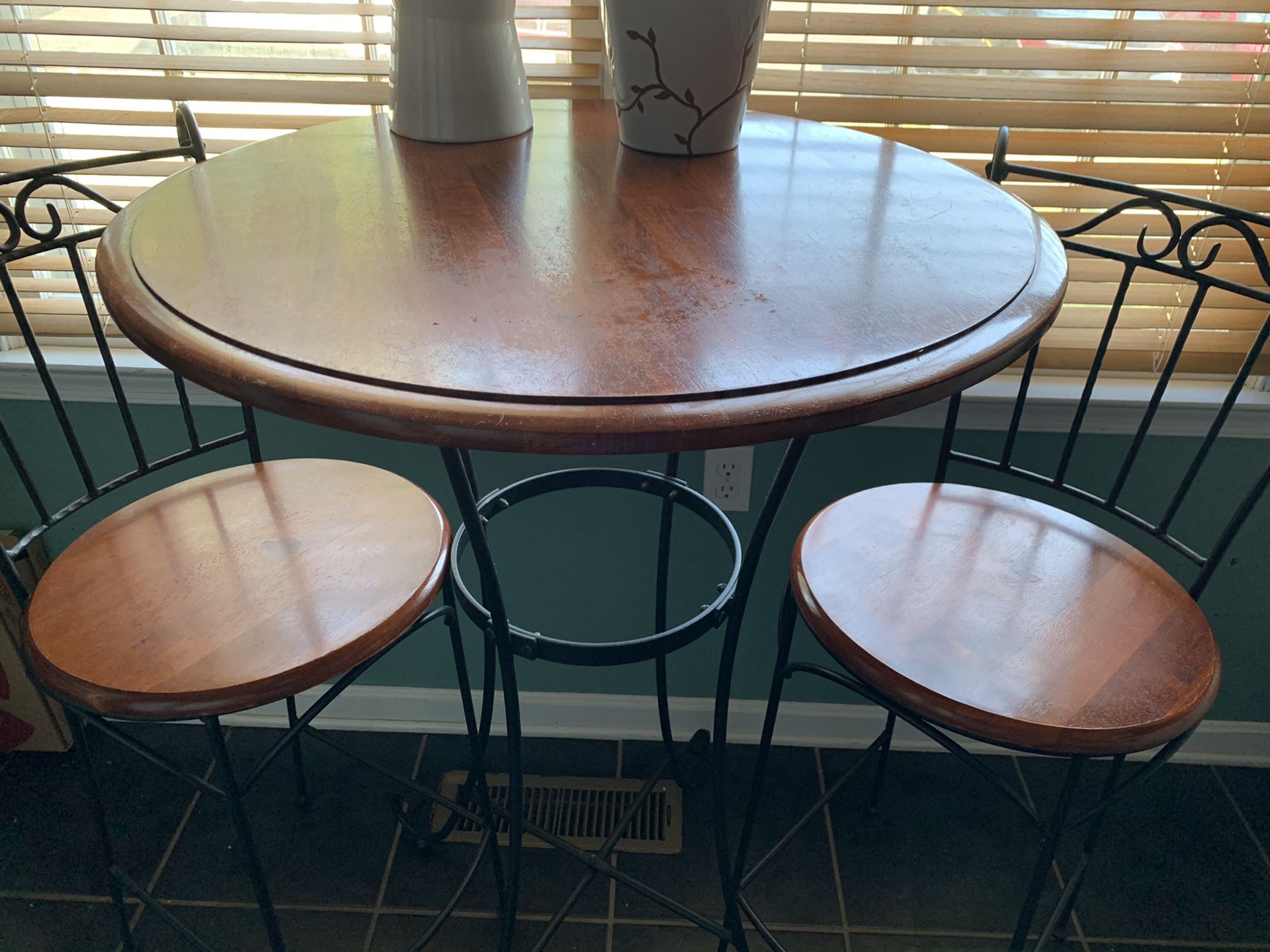Pub table with two bar chairs.