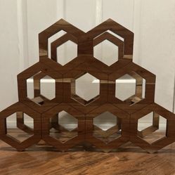 Mid-century modern handmade wooden honeycomb wine rack holds nine bottles