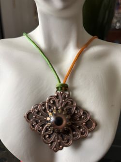 Glass Eye Over Brass Antique Items Hand Crafted & signed By American Glass Artist G. Fone with an adjustable colorful cloth string. 2”x 1.5”