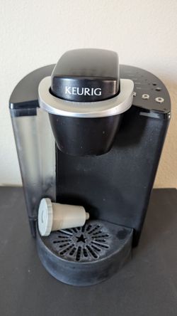Keurig model K40 coffee maker with reusable pod and unopened box of Donut Shop Pods.