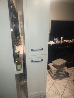 Laundry cabinet with metal shelves