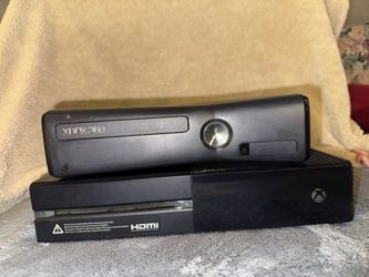 black Xbox 360 console with a separate black Xbox One console visible underneath it