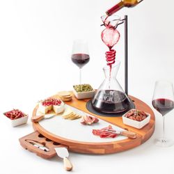 Wine decanter and cheese board with knives.