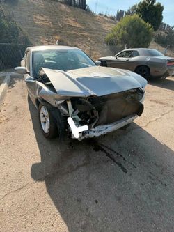 Silver Sedan with Front End Damage Dodge charger 2013